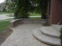 Unilock &#039;Brussell Block&#039; Sierra Paver Patio with Curved Steps and Seating Wall